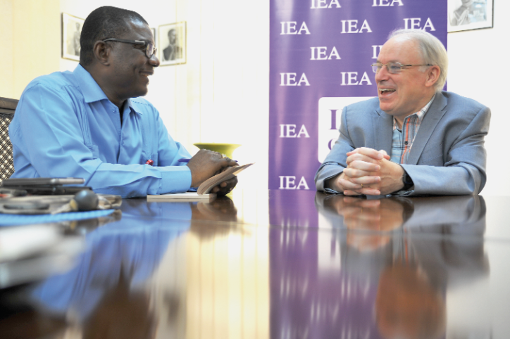 Prof. Gareth Austin (right) explaining a point to Mr Kobby Asmah, Political Editor, Daily Graphic